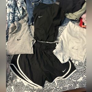 3 Nike tops and 1 pair of shorts